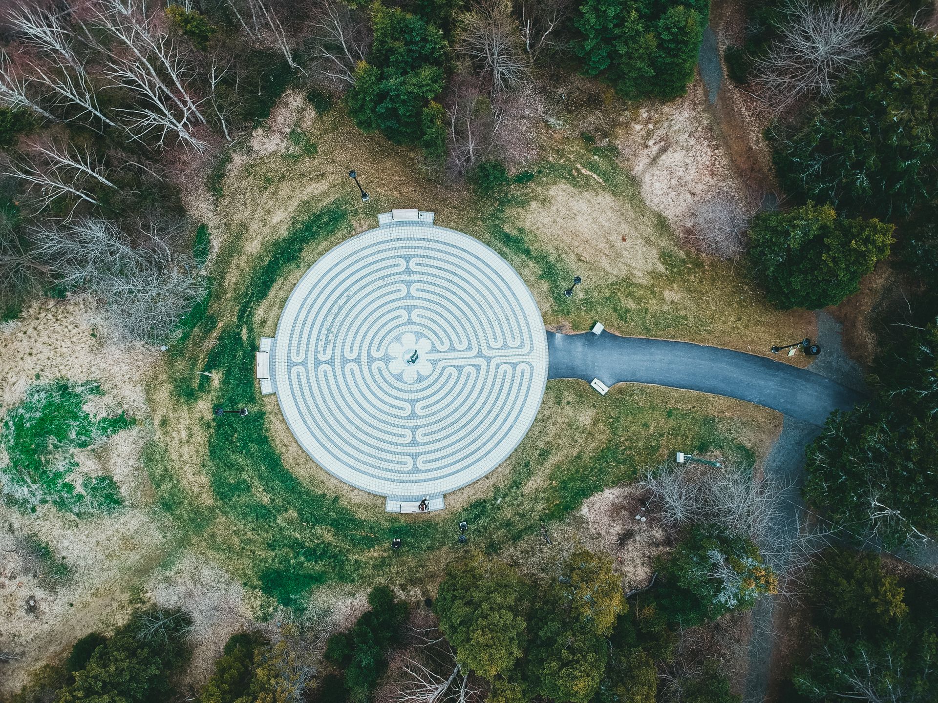 Aerial drone shot of a circular hedge maze, representing navigating web enumeration paths