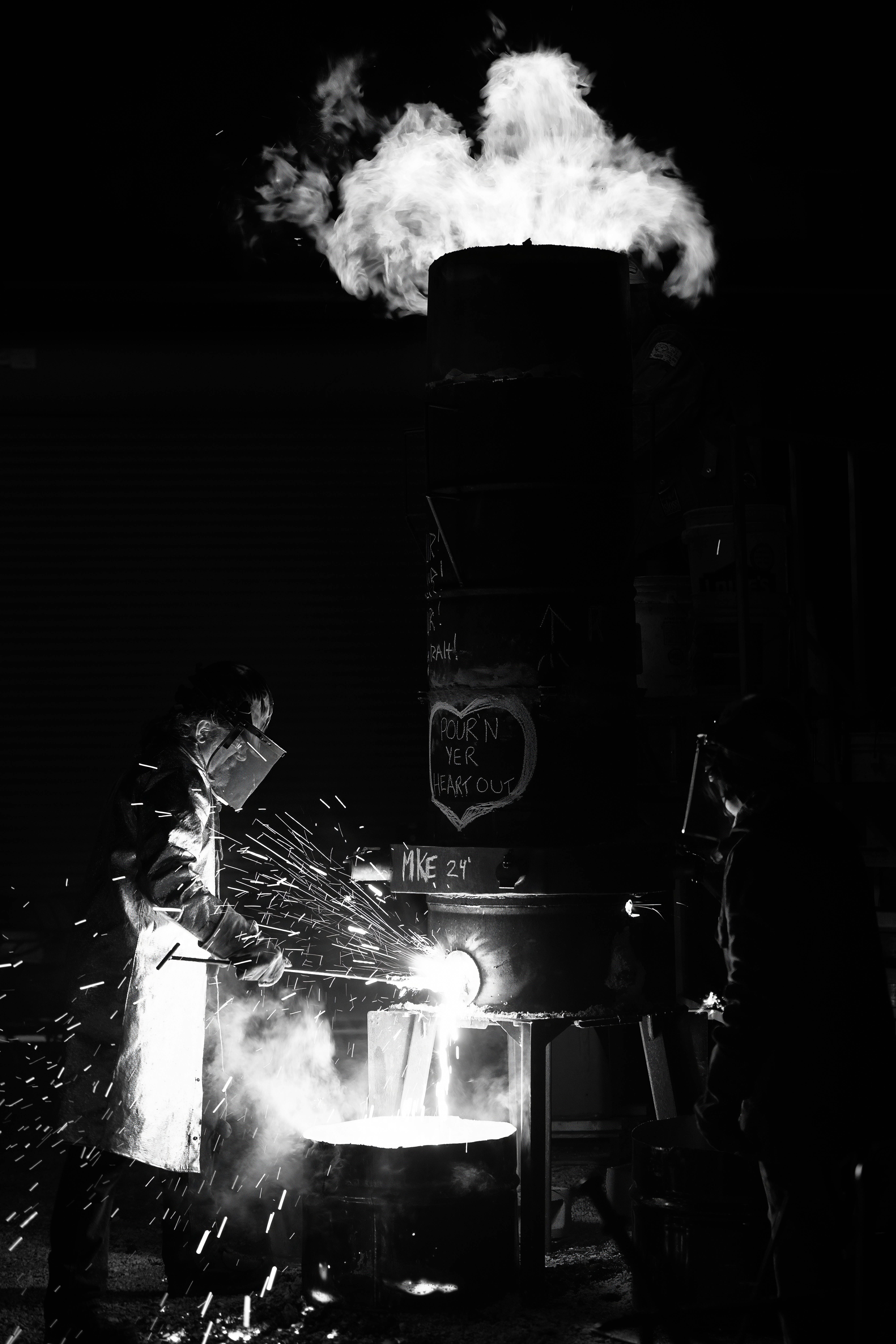 Blacksmith forging metal at night with sparks flying, symbolizing the Forgebound Research relaunch